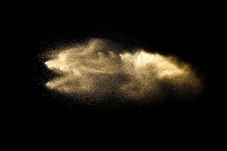 抽象的沙云的沙子飞溅在黑暗的背景中的沙子在空中飞波沙子在黑色背景上爆炸图片
