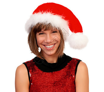 带着圣诞帽子带礼物的欢笑的圣诞节女孩图片