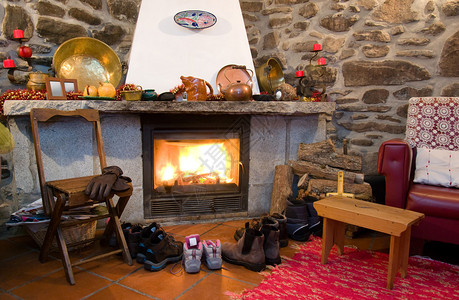 农村家中的壁炉鞋子和靴子在靠近炎图片