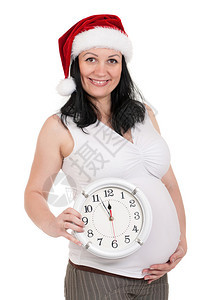 穿着圣塔帽的孕妇长得像时钟超过白色背图片