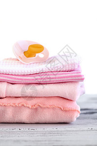 粉色奶嘴和婴儿衣服图片