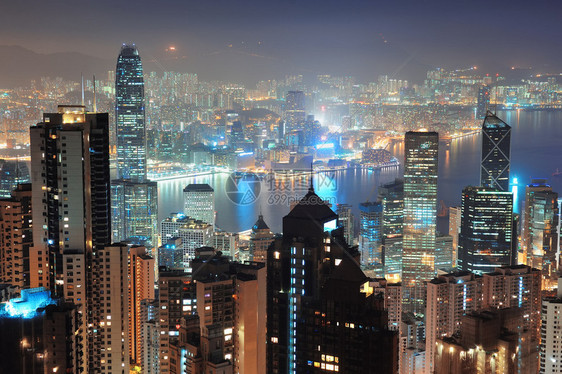 香港市的天际线与维多利亚港和摩天大楼在夜幕下由灯光照亮图片