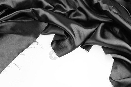 光滑,纯色底纯色背景上波纹黑色丝织物的特写背景