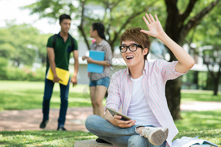 一个学生向某人打招呼的特写镜头图片