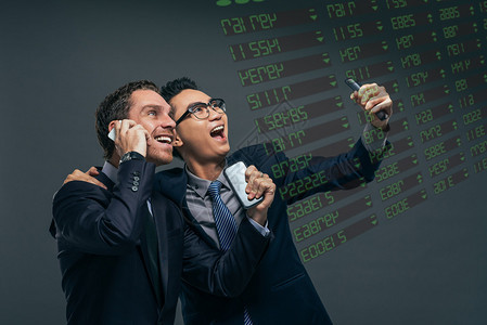 快乐的金融经纪人在看电子股票交易委员会时图片