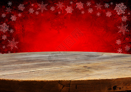 有红色圣诞节背景的空木制甲板桌准备用于产图片