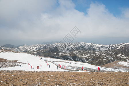 张家口滑雪许多游客在云南省尚格里拉的蓝月谷玩雪背景