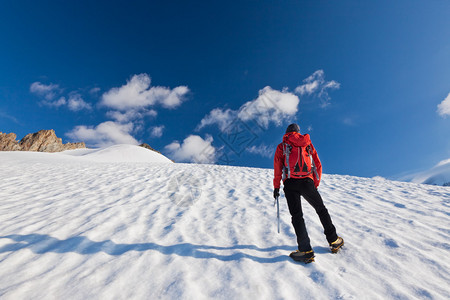 一名男登山者在冰河上爬山图片