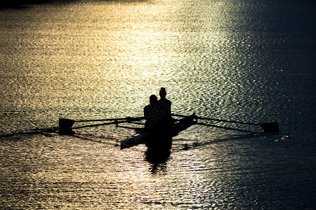 日落湖双桨中的女赛艇运动员图片