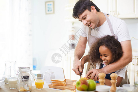 年幼父亲教女儿如何在厨房切面图片