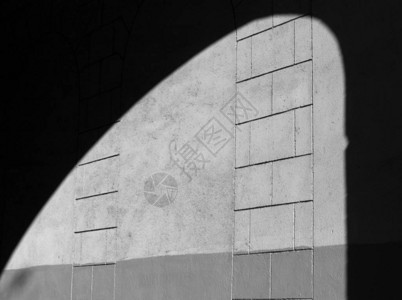黑色和白色石膏彩色墙壁纹理上的拱形阴影图片