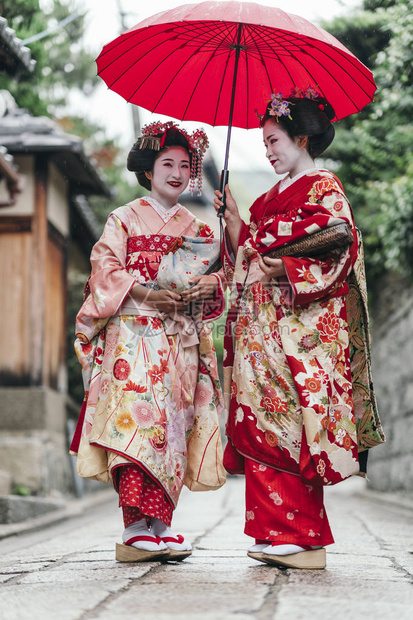 日本京都Gion街上行走的红雨伞艺妓Maiko图片