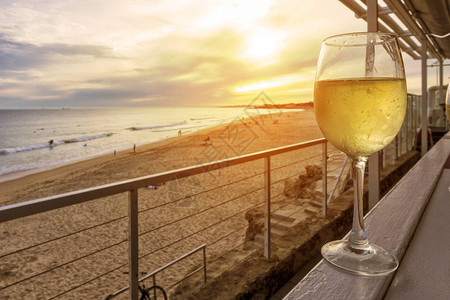 一杯白葡萄酒在木板凳上俯图片