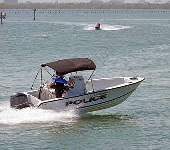 迈阿密海滩警察巡逻艇在迈阿密海滩岸外穿越Florida海背景