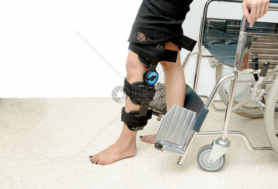 支持膝部扶助的病人尝试步行训图片