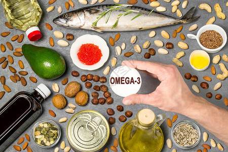 产品脂肪酸Omega3的来源一套富含脂肪酸的天然食品有益健康和均衡饮食的物男人的手拿着带有字样的图片