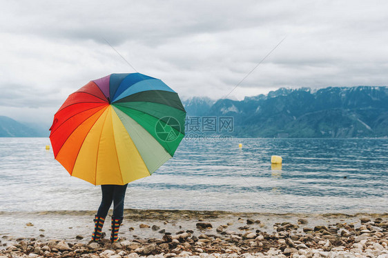 儿童在瑞士日内瓦湖享受令人惊叹的景色带着巨大的多彩雨伞仰图片