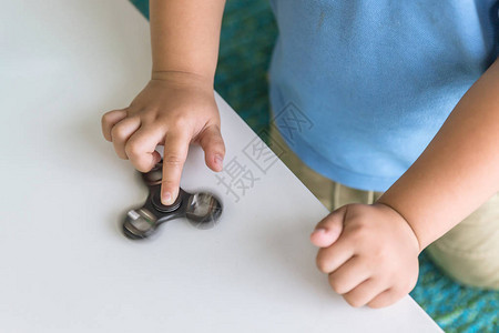 男孩在餐桌上紧贴手上玩打折图片