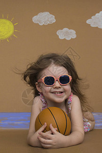 暑假可爱的小女孩在夏日海滩玩耍画上太阳白图片