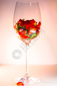 装满红玫瑰花瓣的玻璃花瓶白色背景芳香疗法的概念白色背景芳香疗法的概背景图片