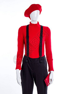 红色贝雷帽毛衣和钱包穿着带吊裤的女模特儿时装图片