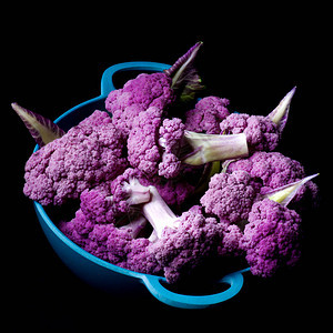蓝色一碗新鮮生紫芽花椰菜和叶子贴图片