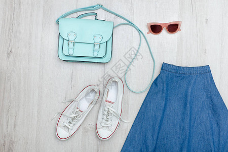 短裙眼镜白运动鞋和手提包时尚概图片