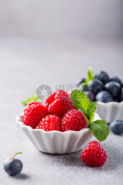白瓷碗有新鲜健康的浆果草莓和蓝图片