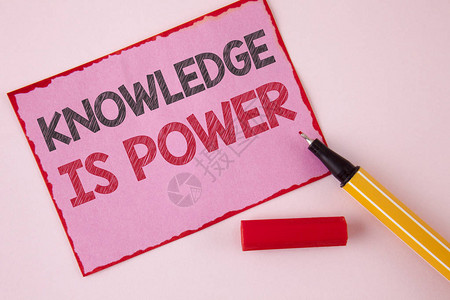显示知识就是力量的文字符号概念照片学习将使您比其他书写的粉红色便笺纸和旁边的普通背图片