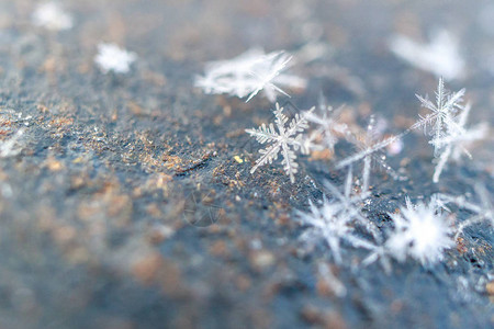 金属略生锈的纹理背景上的雪花特写图片