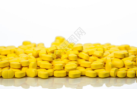 一堆黄色卵形矩状的药片图片