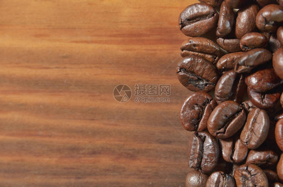 部分咖啡烤豆躺在木制背景上图片