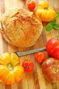 切番茄和面包卷的切面板准备背景图片