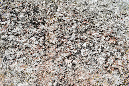 岩石墙壁上天然雕刻固体强粗糙锐纹理矿物灰色棕石头鹅卵石的纹图片