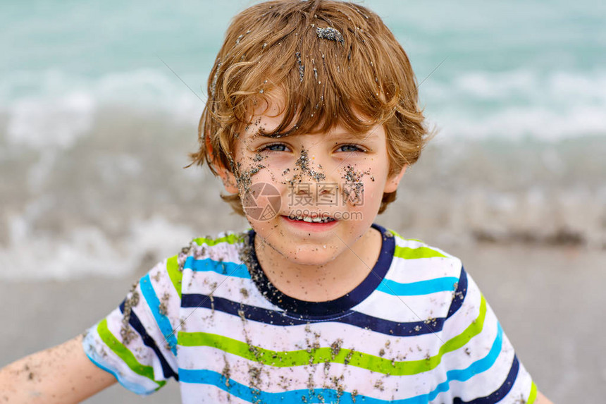 可爱活跃的小男孩在迪拜海滩上玩得开心快乐可爱的孩子在棕榈树和海洋附近放松玩耍和享受暴风雨温暖的一天有趣的美丽脸上图片