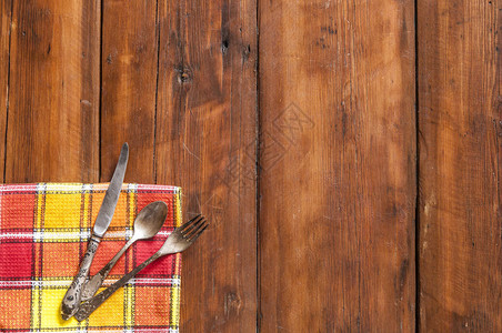 木板上餐巾纸上的叉子和刀子图片