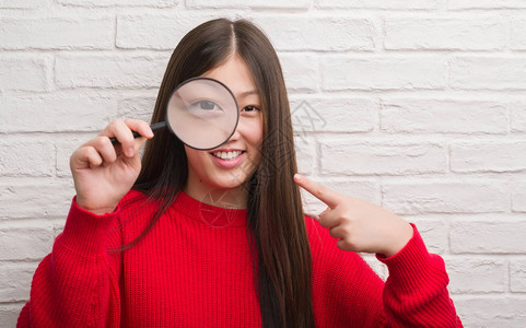 年轻女人在砖墙上翻墙图片