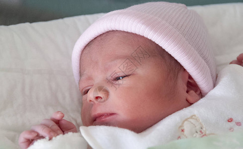 新生婴儿躺在床上出生的第一天图片
