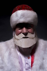 一个年老富豪打扮成圣诞老人和图片