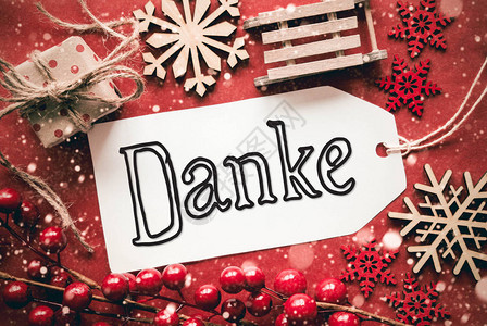 标签与德国书法Danke意味着谢平躺着红色圣诞装饰图片