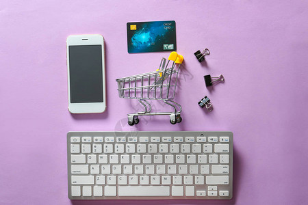 小手推车移动电话和计算机按颜色背景键盘构成的彩色背景图片