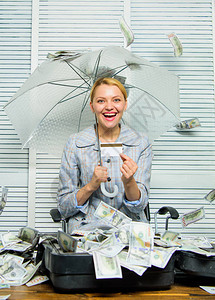 财务上的成功有一堆钱的会计师躲在伞下会计师在办公室享受现金雨现金雨概念钱如雨落女商人图片