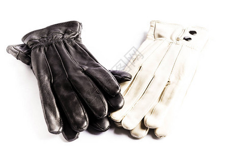 白色背景上的两双优雅的黑白皮手套图片