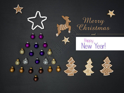 黑色板背景上用圣诞装饰品制成的问候字母和树背景图片