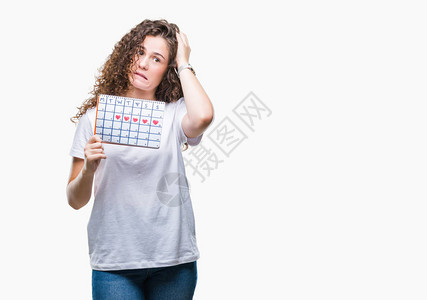 年轻的黑发女孩在孤立的背景下拿着月经日历图片