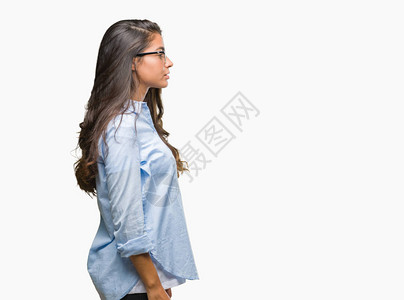 年轻美丽的阿拉伯女人戴着眼镜与世隔绝的背景相望放松姿势和自然面貌充图片