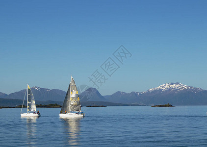 帆船和白帆在美丽的大山背景下的大海中图片