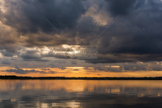 在湖的日落在暴风雨云之后的美丽日落在雷暴之前在湖风景背之上戏剧天空图片