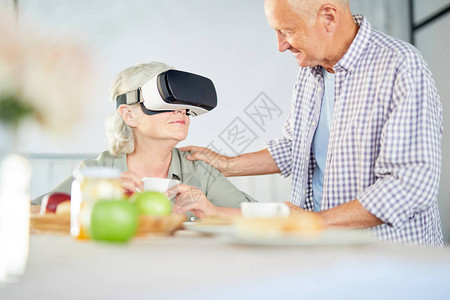老人在厨房谈话时戴着虚拟现实护目镜图片