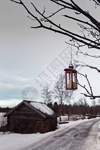 蜡烛几乎从芬兰北部一个渔村的一棵树上挂着的旧金属上掉下来背景图片